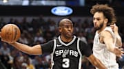 Nov 16, 2024; Dallas, Texas, USA;  San Antonio Spurs guard Chris Paul (3) passes around Dallas Mavericks center Dereck Lively II (2) during the first half at American Airlines Center. Mandatory Credit: Kevin Jairaj-Imagn Images