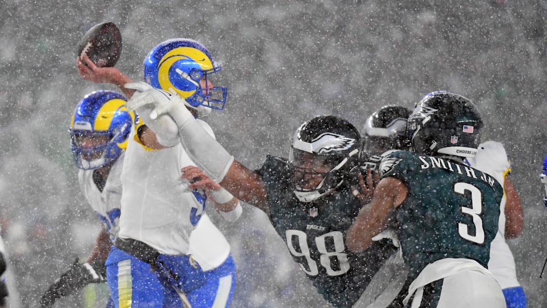 Jan 19, 2025; Philadelphia, Pennsylvania, USA;Los Angeles Rams quarterback Matthew Stafford (9) is pressured by Philadelphia Eagles defensive tackle Jalen Carter (98) during the fourth quarter in a 2025 NFC divisional round game at Lincoln Financial Field. Mandatory Credit: Eric Hartline-Imagn Images