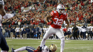 Sep 25, 2021; Columbus, Ohio, USA; Ohio State Buckeyes running back TreVeyon Henderson (32) runs in the touchdown over Akron Zips safety Jaylen Kelly-Powell (8)during the first quarter at Ohio Stadium. Mandatory Credit: Joseph Maiorana-USA TODAY Sports