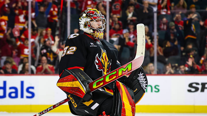 Nov 19, 2024; Calgary, Alberta, CAN; Calgary Flames goaltender Dustin Wolf (32) celebrate win with teammates after defeating New York Islanders at Scotiabank Saddledome. Mandatory Credit: Sergei Belski-Imagn Images