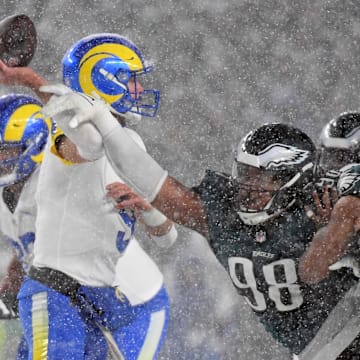 Jan 19, 2025; Philadelphia, Pennsylvania, USA; Los Angeles Rams quarterback Matthew Stafford (9) is pressured by Philadelphia Eagles defensive tackle Jalen Carter (98) during the fourth quarter in a 2025 NFC divisional round game at Lincoln Financial Field. 