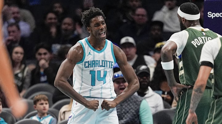 Feb 5, 2025; Charlotte, North Carolina, USA; Charlotte Hornets forward Moussa Diabate (14) reacts to his three point play against the Milwaukee Bucks during the second quarter at Spectrum Center. Mandatory Credit: Jim Dedmon-Imagn Images