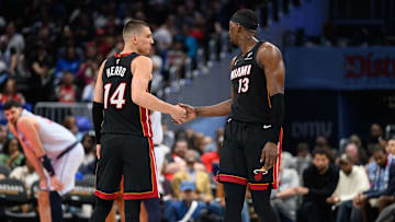 Mar 31, 2025; Washington, District of Columbia, USA; Miami Heat guard Tyler Herro (14) and center Bam Adebayo (13) react during the third quarter against the Washington Wizards at Capital One Arena. Mandatory Credit: Reggie Hildred-Imagn Images