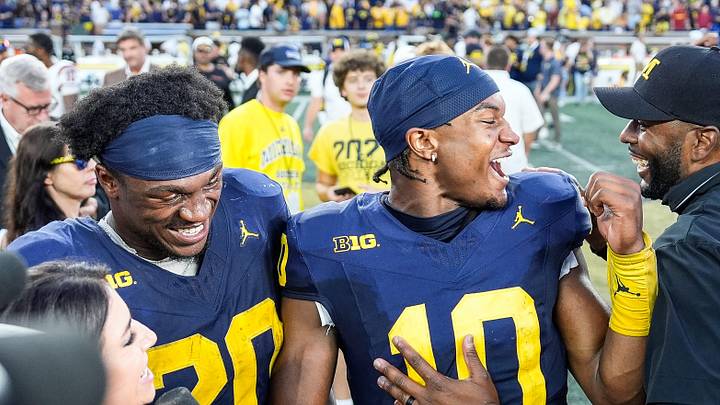 Michigan head coach Sherrone Moore, right, talks to quarterback Alex Orji (10) and running back Kalel Mullings (20) after 27-24 win over USC at Michigan Stadium in Ann Arbor on Saturday, Sept. 21, 2024.