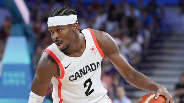 Aug 2, 2024; Villeneuve-d'Ascq, France;  Canada guard Shai Gilgeous-Alexander (2) controls the ball against Spain small forward Alex Abrines (21) in the second half in a men’s group A basketball game during the Paris 2024 Olympic Summer Games at Stade Pierre-Mauroy. Mandatory Credit: John David Mercer-USA TODAY Sports