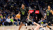 Dec 8, 2025; New Orleans, Louisiana, USA;  New Orleans Pelicans center Derik Queen (22) brings the ball up court against San Antonio Spurs center/forward Luke Kornet (7) during the second half at Smoothie King Center. Mandatory Credit: Stephen Lew-Imagn Images