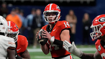 Georgia quarterback Gunner Stockton (14) looks to throw a pass during overtime of the SEC championship game against Texas in Atlanta, on Saturday, Dec. 7, 2024.