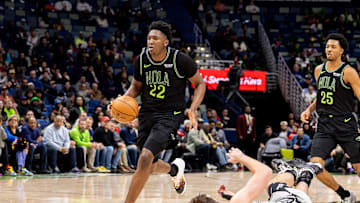 Dec 8, 2025; New Orleans, Louisiana, USA;  New Orleans Pelicans center Derik Queen (22) brings the ball up court against San Antonio Spurs center/forward Luke Kornet (7) during the second half at Smoothie King Center. Mandatory Credit: Stephen Lew-Imagn Images