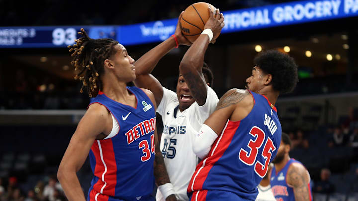 Oct 6, 2025; Memphis, Tennessee, USA; Memphis Grizzlies forward GG Jackson II (45) attempts to drive to the basket between Detroit Pistons forwards Bobi Klintman (34) and Tolu Smith (35) during the fourth quarter at FedExForum. 