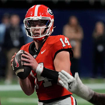 Georgia quarterback Gunner Stockton (14) looks to throw a pass during overtime of the SEC championship game against Texas in Atlanta, on Saturday, Dec. 7, 2024.