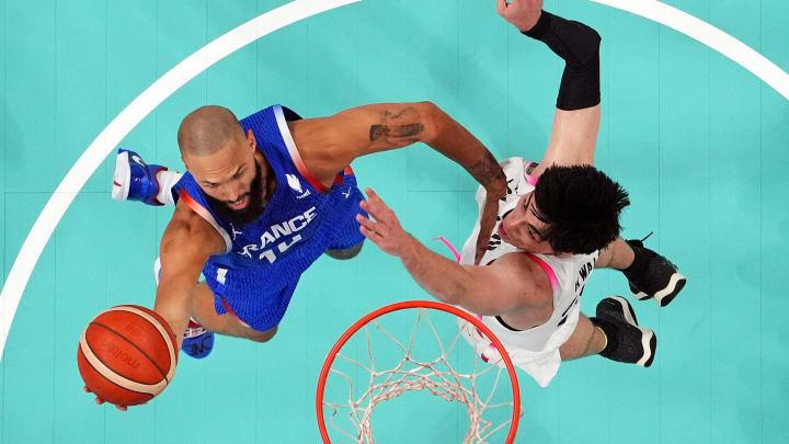 Jul 30, 2024; Villeneuve-d'Ascq, France; France shooting guard Evan Fournier (10) shoots the ball against Japan centre Hugh Watanabe (34) in men’s basketball group B play during the Paris 2024 Olympic Summer Games at Stade Pierre-Mauroy. Mandatory Credit: John David Mercer-USA TODAY Sports