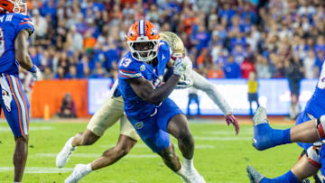 Nov 29, 2025; Gainesville, Florida, USA; Florida Gators running back Jadan Baugh (13) runs the ball during the second quarter against the Florida State Seminoles at Ben Hill Griffin Stadium. Mandatory Credit: Bob Kupbens-Imagn Images