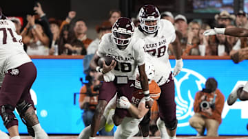 Nov 28, 2025; Austin, Texas, USA; Texas A&M Aggies quarterback Marcel Reed (10) keeps the ball for yards during the first half against the Texas Longhorns at Darrell K Royal-Texas Memorial Stadium. Mandatory Credit: Scott Wachter-Imagn Images