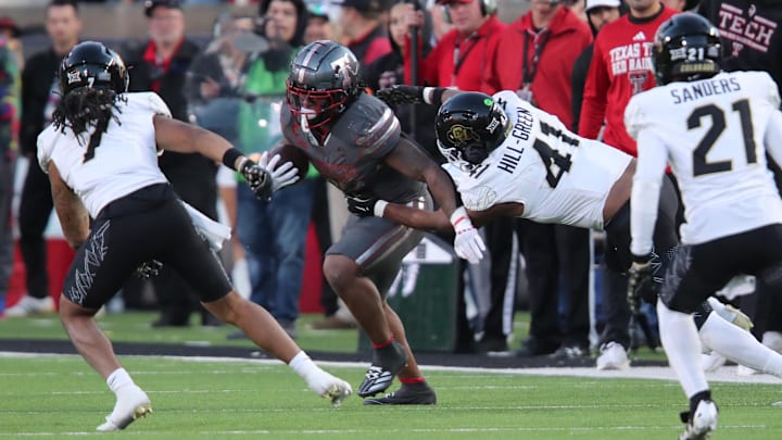 Colorado defensive back Nikhai Hill-Green tackles Texas Tech running back Tahj Brooks.
