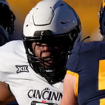 Cincinnati Bearcats defensive lineman Dontay Corleone (2) rushes the quarterback as West Virginia Mountaineers offensive lineman Zach Frazier (54) blocks in the first quarter during an NCAA college football game between the Cincinnati Bearcats and the West Virginia Mountaineers, Saturday, Nov. 18, 2023, at Milan Puskar Stadium in Morgantown, W. Va.