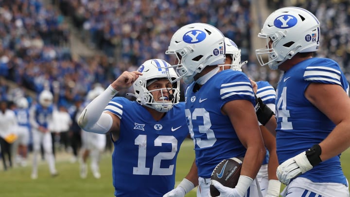 Nov 18, 2023; Provo, Utah, USA; Brigham Young Cougars quarterback Jake Retzlaff (12) celebrates a touchdown with tight end Isaac Rex (83) in the second quarter at LaVell Edwards Stadium. Mandatory Credit: Rob Gray-USA TODAY Sports