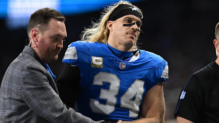 Detroit Lions linebacker Alex Anzalone (34) gets escorted off the field after suffering arm injury