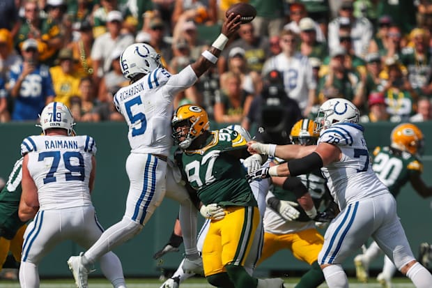 Indianapolis Colts quarterback Anthony Richardson throws the ball under pressure in a white jersey.