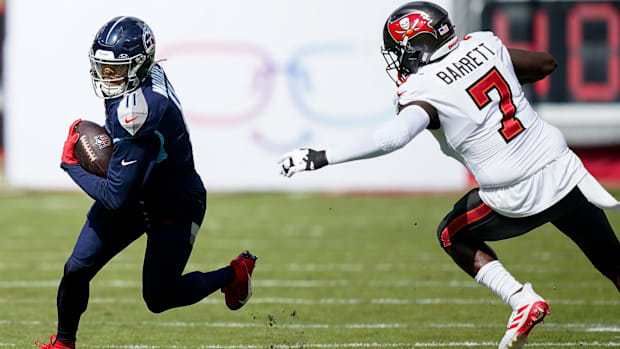 Defensive end Shaquil Barrett (white jersey) tries to get after the ball-carrier.
