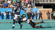 Dec 19, 2022; Conway, South Carolina, USA; Connecticut Huskies quarterback Zion Turner (11) runs the ball past Marshall Thundering Herd safety Isaiah Norman (8) in the first half in the Myrtle Beach Bowl at Brooks Stadium. Mandatory Credit: David Yeazell-Imagn Images