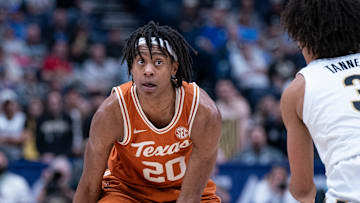 Texas Longhorns guard Tre Johnson (20) looks for an opening against Vanderbilt Commodores guard Tyler Tanner (3) during their first round game of the SEC Men's Basketball Tournament at Bridgestone Arena in Nashville, Tenn., Wednesday, March 12, 2025.
