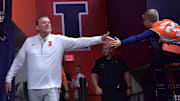 Nov 4, 2024; Champaign, Illinois, USA;  Illinois Fighting Illini head coach Brad Underwood gets a hand from a young fan before a game against the Eastern Illinois Panthers at State Farm Center. Mandatory Credit: Ron Johnson-Imagn Images