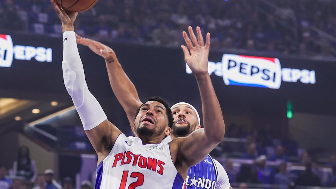 Apr 27, 2026; Orlando, Florida, USA; Detroit Pistons forward Tobias Harris (12) goes to the basket against Orlando Magic guard Jalen Suggs (4) during the first quarter during game four of the first round of the 2026 NBA Playoffs at Kia Center. Mandatory Credit: Mike Watters-Imagn Images