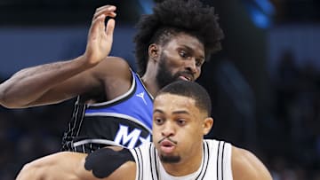 San Antonio Spurs forward Keldon Johnson moves the ball past Orlando Magic forward Jonathan Isaac