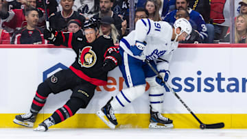 Apr 26, 2025; Ottawa, Ontario, CAN; Toronto Maple Leafs center John Tavares (91) evades a check from Ottawa Senators center Nick Cousins (21) in game four of the first round of the 2025 Stanley Cup Playoffs at Canadian Tire Centre. Mandatory Credit: Marc DesRosiers-Imagn Images