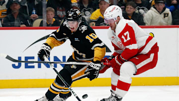 Apr 11, 2024; Pittsburgh, Pennsylvania, USA;  Pittsburgh Penguins left wing Drew O'Connor (10) and Detroit Red Wings right wing Daniel Sprong (17) chase the puck during the third period at PPG Paints Arena. Mandatory Credit: Charles LeClaire-Imagn Images