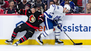 Apr 26, 2025; Ottawa, Ontario, CAN; Toronto Maple Leafs center John Tavares (91) evades a check from Ottawa Senators center Nick Cousins (21) in game four of the first round of the 2025 Stanley Cup Playoffs at Canadian Tire Centre. Mandatory Credit: Marc DesRosiers-Imagn Images