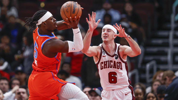 Jan 13, 2023; Chicago, Illinois, USA; Oklahoma City Thunder guard Luguentz Dort (5) looks to pass the ball against Chicago Bulls guard Alex Caruso (6) during the first half at United Center. Mandatory Credit: Kamil Krzaczynski-USA TODAY Sports