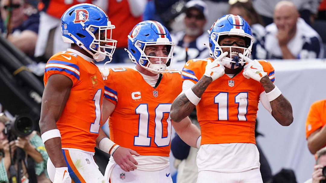Oct 26, 2025; Denver, Colorado, USA;  Denver Broncos wide receiver Troy Franklin (11) celebrates with wide receiver Courtland Sutton (14) and quarterback Bo Nix (10) after scoring a touchdown against the Dallas Cowboys in the fourth quarter at Empower Field at Mile High. Mandatory Credit: Ron Chenoy-Imagn Images