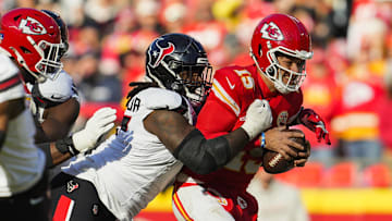 Dec 21, 2024; Kansas City, Missouri, USA; Kansas City Chiefs quarterback Patrick Mahomes (15) is tackled by Houston Texans defensive tackle Mario Edwards Jr. (97) during the first half at GEHA Field at Arrowhead Stadium. Mandatory Credit: Jay Biggerstaff-Imagn Images