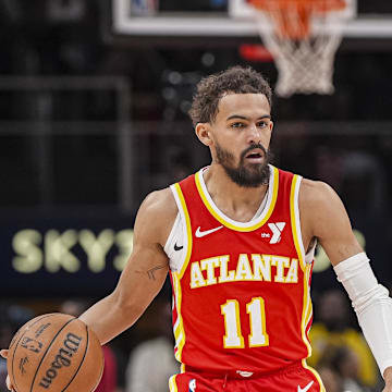 Mar 14, 2025; Atlanta, Georgia, USA; Atlanta Hawks guard Trae Young (11) dribbles against LA Clippers forward Derrick Jones Jr. (55) during the first half at State Farm Arena. Mandatory Credit: Dale Zanine-Imagn Images