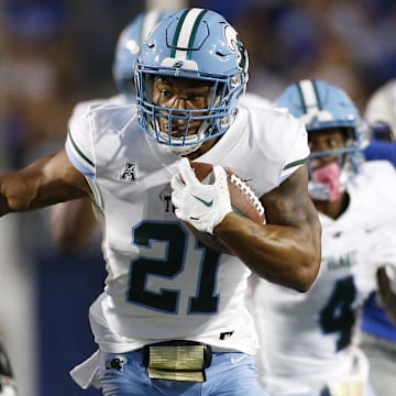Oct 13, 2023; Memphis, Tennessee, USA; Tulane Green Wave running back Makhi Hughes (21) runs with the ball during the first half against the Memphis Tigers at Simmons Bank Liberty Stadium. Mandatory Credit: Petre Thomas-Imagn Images