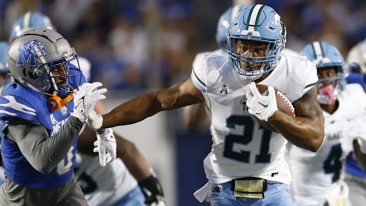 Oct 13, 2023; Memphis, Tennessee, USA; Tulane Green Wave running back Makhi Hughes (21) runs with the ball during the first half against the Memphis Tigers at Simmons Bank Liberty Stadium. Mandatory Credit: Petre Thomas-Imagn Images Oct 13, 2023; Memphis, Tennessee, USA; Tulane Green Wave running back Makhi Hughes (21) runs with the ball during the first half against the Memphis Tigers at Simmons Bank Liberty Stadium. Mandatory Credit: Petre Thomas-Imagn Images