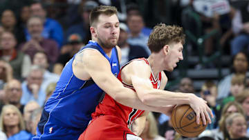 Nov 6, 2024; Dallas, Texas, USA;  Dallas Mavericks guard Luka Doncic (77) tries to steal the ball from Chicago Bulls forward Matas Buzelis (14)