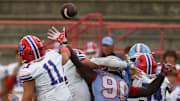 Vestavia Hills' Charles Taaffe (11) throws a pass over Hillcrest High defensive lineman Tayvion Johnson (90) at Hillcrest High School Friday Sept. 13, 2024.