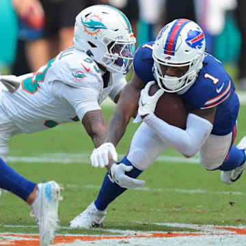 Nov 9, 2025; Miami Gardens, Florida, USA; Miami Dolphins cornerback Jason Marshall Jr. (33) tackles Buffalo Bills wide receiver Curtis Samuel (1).