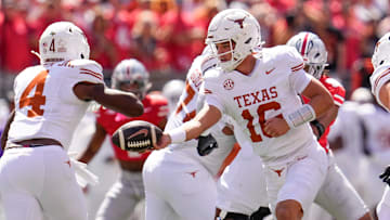 Texas Longhorns quarterback Arch Manning hands off to running back CJ Baxter during the NCAA football game against the Ohio State Buckeyes at Ohio Stadium.