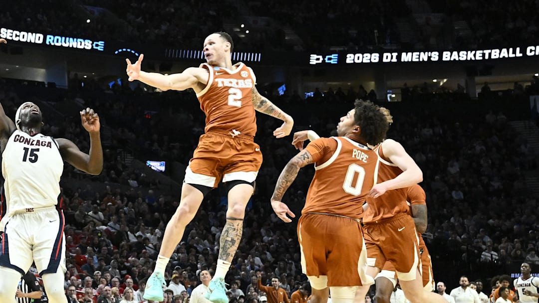 Gonzaga Bulldogs forward Graham Ike (15) and Texas Longhorns guard Chendall Weaver (2) rebound in the second half during a second round game of the men's 2026 NCAA Tournament at Moda Center.