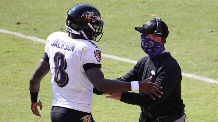 Oct 4, 2020; Landover, Maryland, USA; Baltimore Ravens quarterback Lamar Jackson (8) celebrates with Ravens head coach John Harbaugh (R) after scoring a touchdown against the Washington Football Team in the second quarter at FedExField. Mandatory Credit: Geoff Burke-USA TODAY Sports