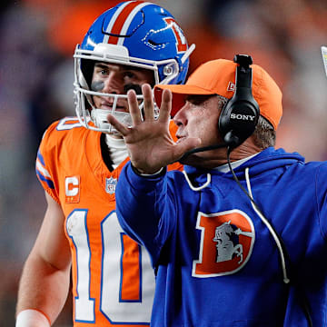 Nov 6, 2025; Denver, Colorado, USA; Denver Broncos quarterback Bo Nix (10) talks with head coach Sean Payton in the fourth quarter against the Las Vegas Raiders at Empower Field at Mile High. 