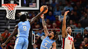 Mar 21, 2025; Milwaukee, WI, USA; North Carolina Tar Heels guard Drake Powell (9) and guard RJ Davis (4) rebound against Mississippi Rebels guard Matthew Murrell (11) during the first half of a first round NCAA men’s tournament game at Fiserv Forum. Mandatory Credit: Benny Sieu-Imagn Images