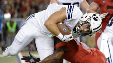 Sep 1, 2018; Tucson, AZ, USA; Brigham Young Cougars running back Lopini Katoa (4) is tackled by Arizona Wildcats cornerback Tim Hough (8) during the second half at Arizona Stadium. Mandatory Credit: Casey Sapio-Imagn Images
