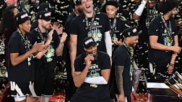 Dec 17, 2024; Las Vegas, Nevada, USA; Milwaukee Bucks forward Giannis Antetokounmpo (34) bites his medal and celebrates with players and staff after winning the Emirates NBA Cup championship game against the Oklahoma City Thunder at T-Mobile Arena. Mandatory Credit: Candice Ward-Imagn Images