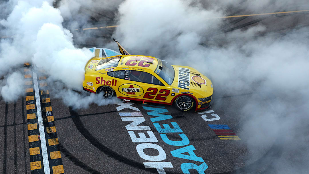 Joey Logano celebrates his third NASCAR Cup Series championship after winning Sunday's event at Phoenix Raceway.