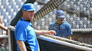 Jun 14, 2025; Omaha, Neb, USA;  UCLA Bruins head coach John Savage watches the team warm up before the game against the Murray State Races at Charles Schwab Field. Mandatory Credit: Steven Branscombe-Imagn Images