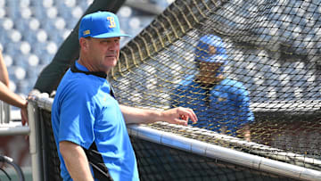 Jun 14, 2025; Omaha, Neb, USA;  UCLA Bruins head coach John Savage watches the team warm up before the game against the Murray State Races at Charles Schwab Field. Mandatory Credit: Steven Branscombe-Imagn Images
